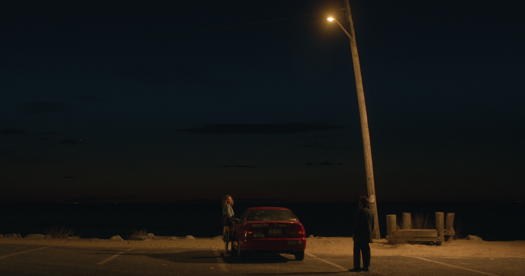 Tim Blake Nelson, Mirelle Enos meet in a parking lot in Montauk