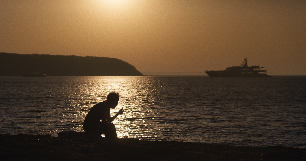 Tim Blake Nelson sits on the Montauk waterfront watching the sunset